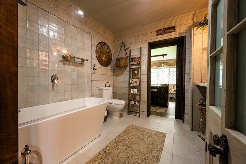 Freestanding bathtub with tiled walls and timber accents, Maxwell bathroom redesign