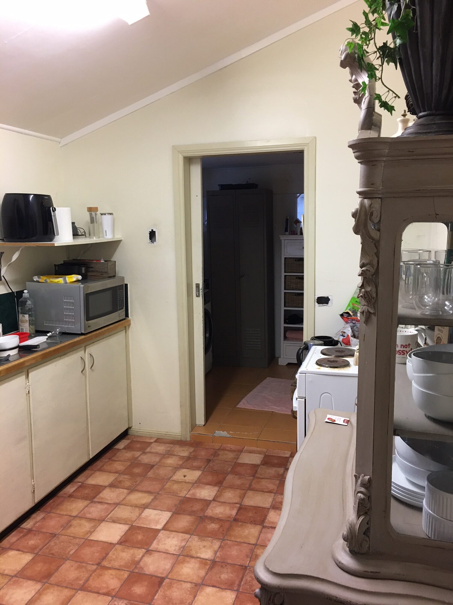 Outdated kitchen before renovation, patterned tile flooring and worn cabinetry, Cambridge kitchen redesign