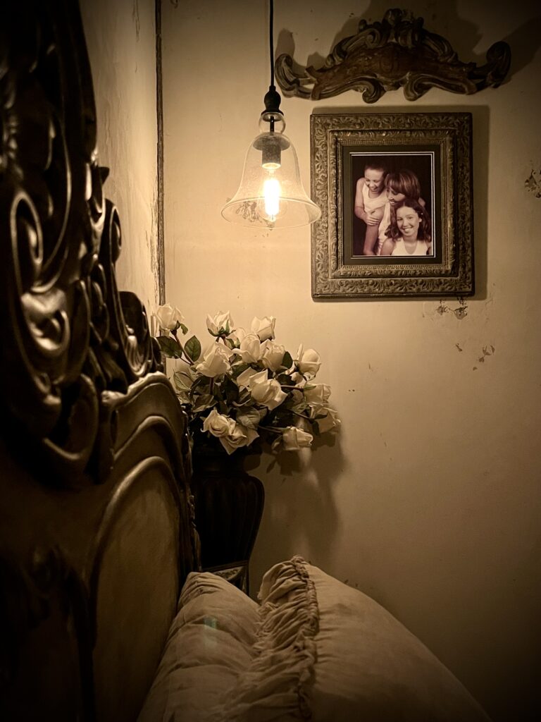 Cozy bedroom corner with ornate carved bedframe and warm pendant lighting, Maxwell bedroom styling
