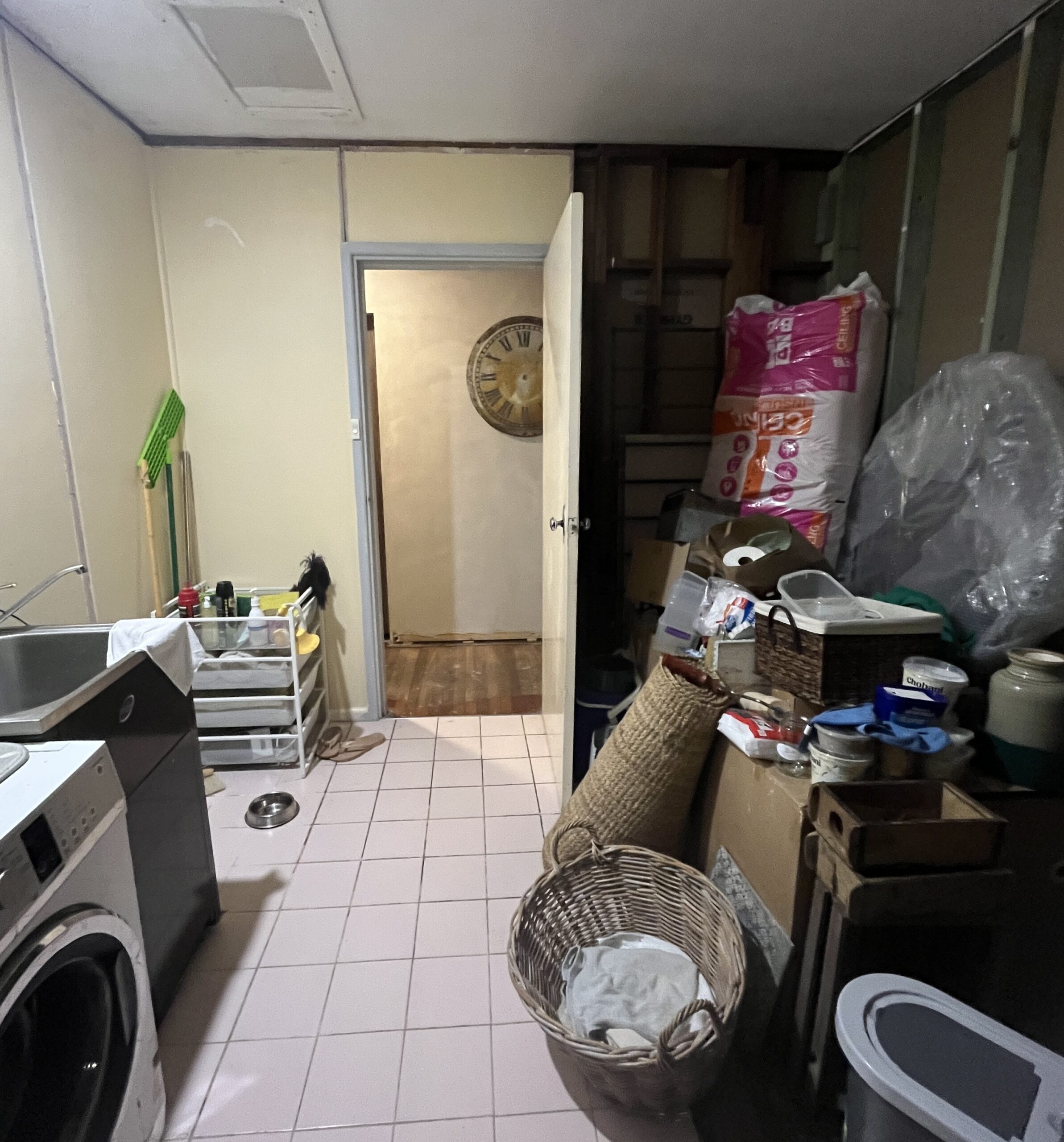 Cluttered laundry and storage space before renovation, Maxwell bathroom redesign