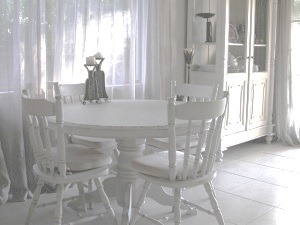 Bright dining nook with round white table and chairs, Jacaranda living space redesign